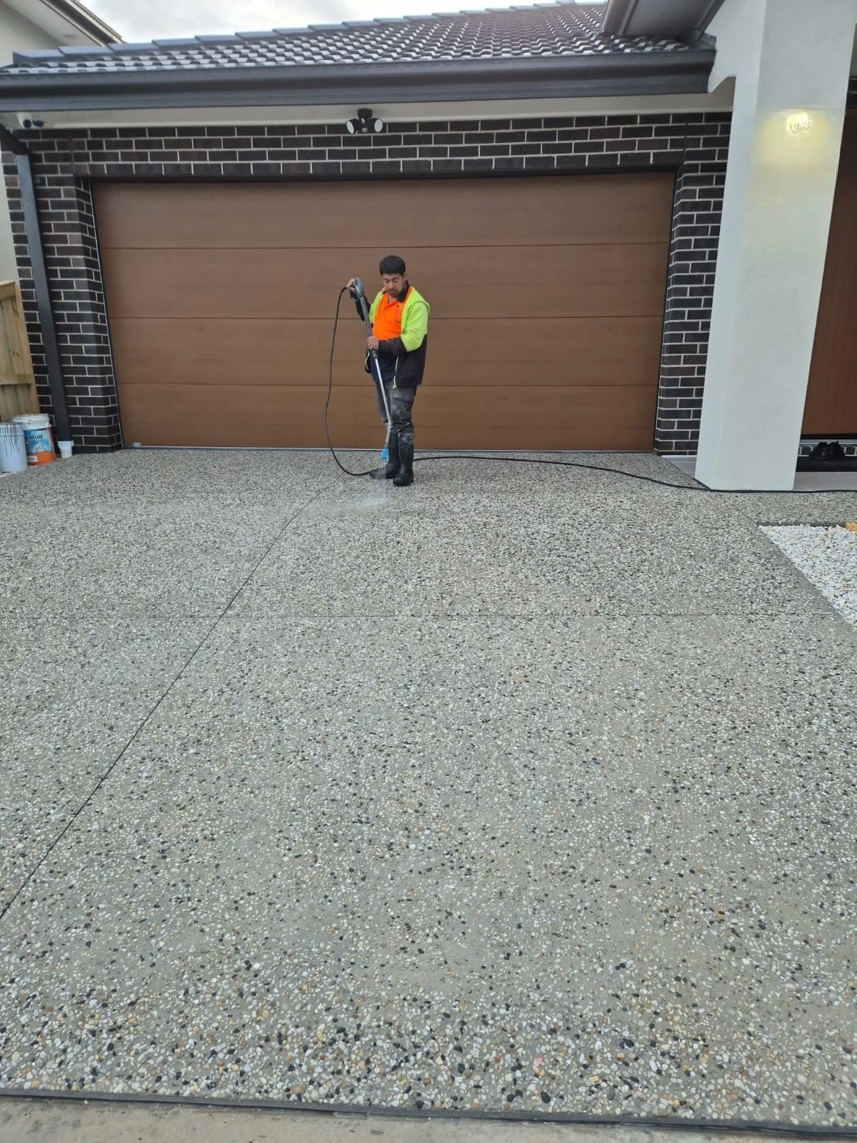 cleaning driveway after exposed aggregate concreting work